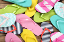 Colorful Flip Flops on Wooden Table