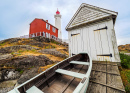 Old Lighthouse with a Shed and Boat