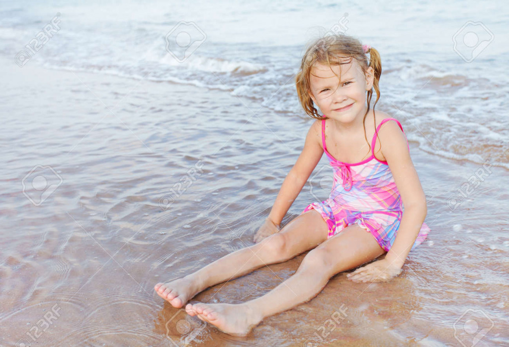 18202351-adorable-happy-smiling-girl-sitting-on-beach jigsaw puzzle in PJ Hunter puzzles on TheJigsawPuzzles.com