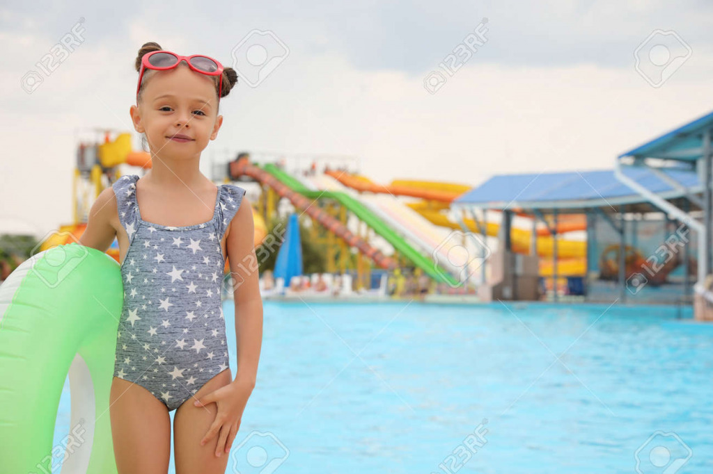 172867909-cute-little-girl-with-inflatable-ring-near-pool-in-water-park-space-for-text jigsaw puzzle in PJ Hunter puzzles on TheJigsawPuzzles.com