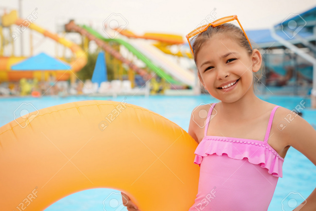 172867913-cute-little-girl-with-inflatable-ring-near-pool-in-water-park jigsaw puzzle in PJ Hunter puzzles on TheJigsawPuzzles.com
