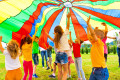 Happy Kids under a Colorful Parachute