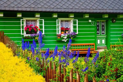 Colourful Cottage Facade and Blooming Flowers